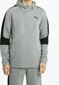 Grijze hoodie met ritssluiting van sweatshirtmateriaal, met zwarte zijpanelen, een capuchon met trekkoord en een klein zwart logo op de borst.