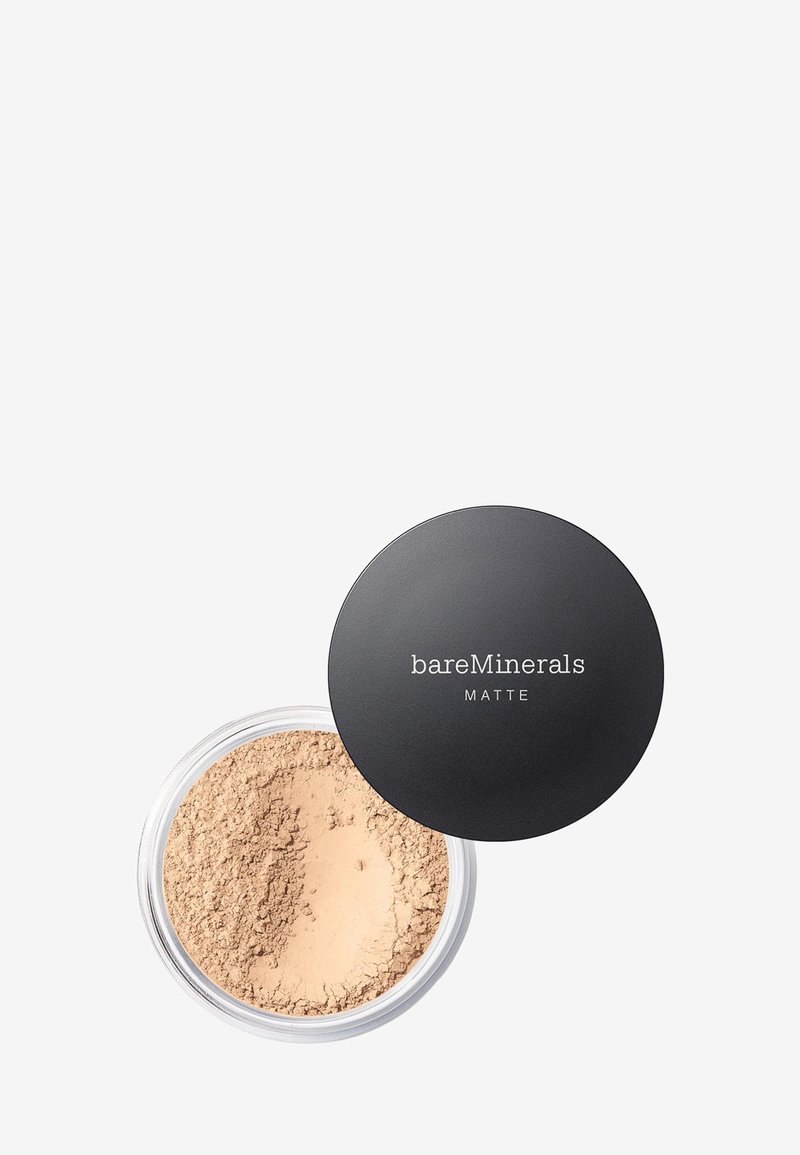 Polvo mate de BareMinerals en un envase transparente con tapa negra. Polvo beige claro visible en el interior, de textura fina y acabado suave.