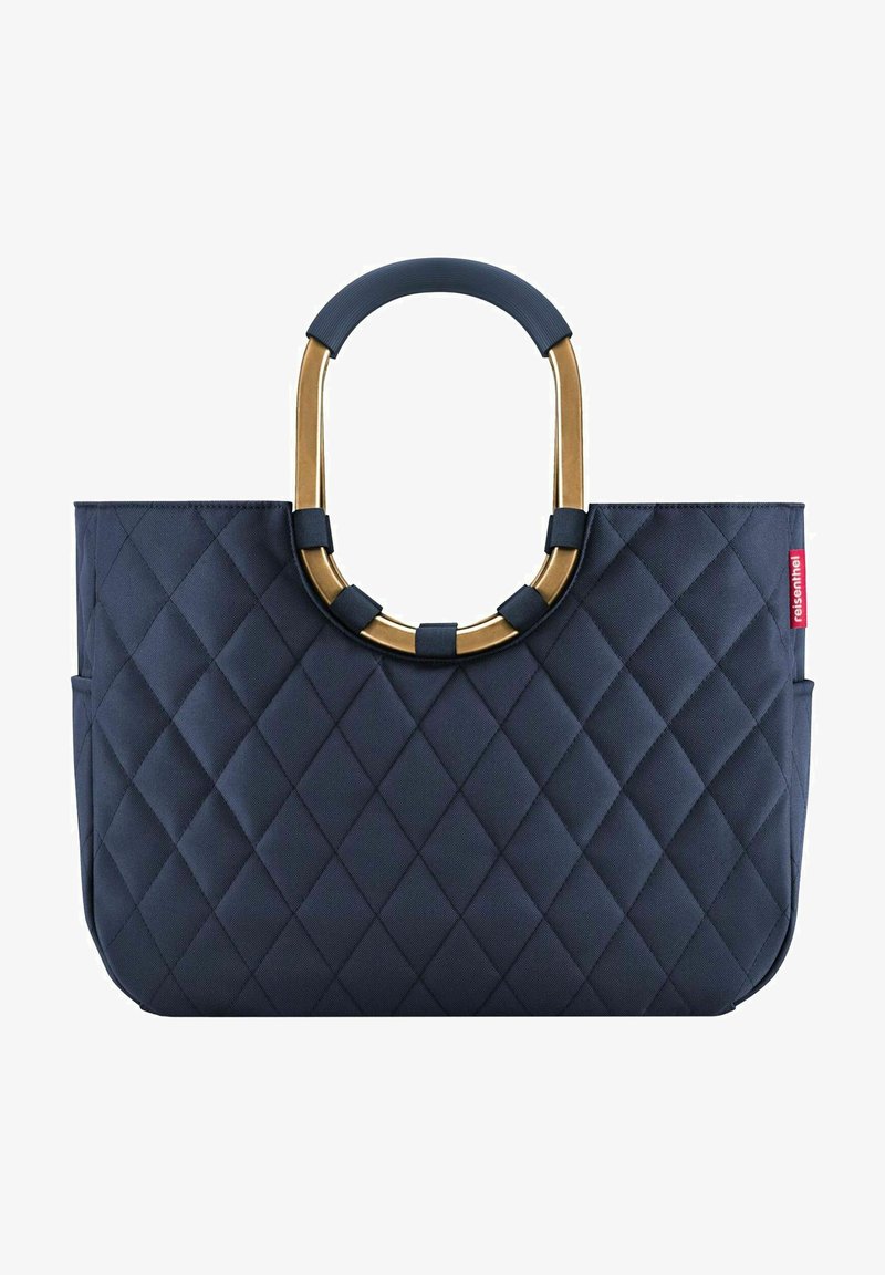 Navy quilted tote bag with a gold-hued metal handle, featuring a smooth texture and geometric diamond pattern on the surface.