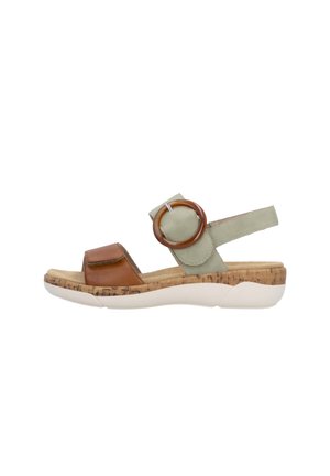 Cork-soled sandal with brown leather toe strap, green adjustable ankle strap with circular accent, and white rubber sole.