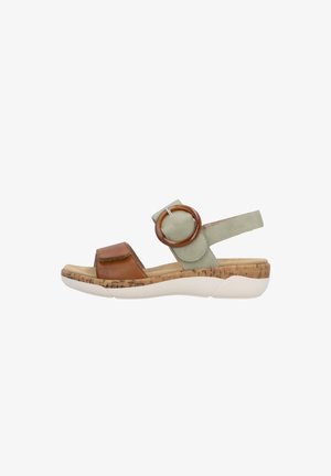 Cork-soled sandal with brown leather toe strap, green adjustable ankle strap with circular accent, and white rubber sole.