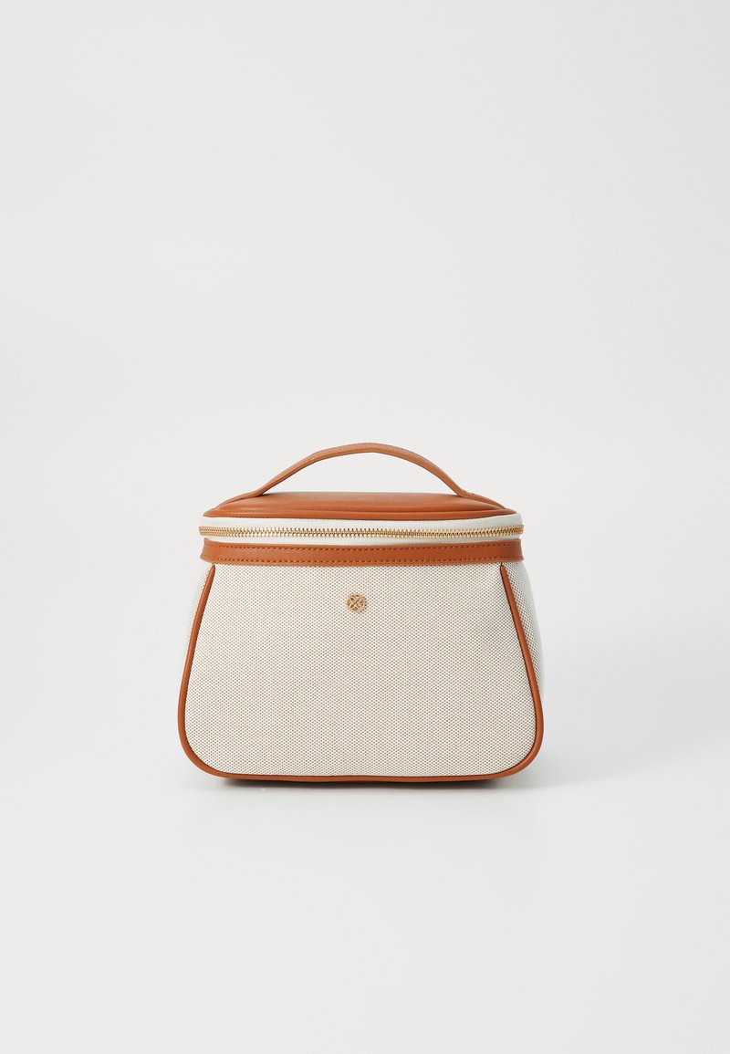 Textured cream bag with a structured shape, brown leather accents, a top handle, and a zipper closure featuring a small logo detail.