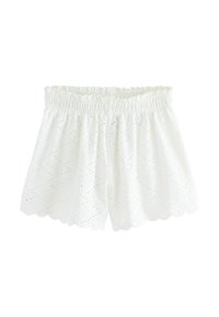 Shorts en coton blancs avec un ourlet festonné, une taille élastique et un motif texturé avec de petites découpes sur tout le tissu.