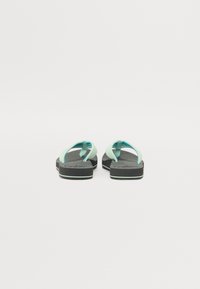 Pair of black and light blue flip-flops with cushioned soles, viewed from the back on a white background.