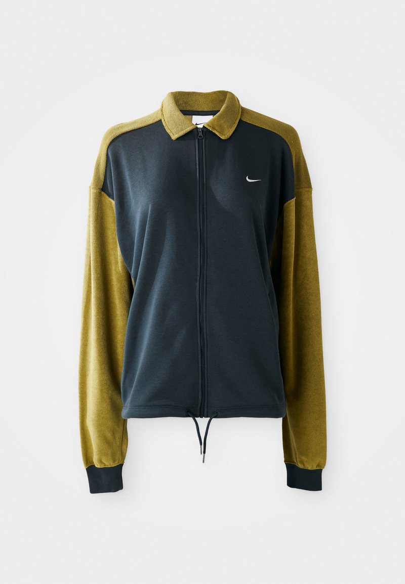 Zipped jacket with a dark navy body and olive green sleeves. Features a collar, drawstring hem, and a small white logo on the chest.
