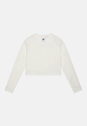 Kraten zgornji del dolgega rokava v off-white tkanini z gladko teksturo. Ima okrogel ovratnik in majhen odsevni Nike logotip na prsih.