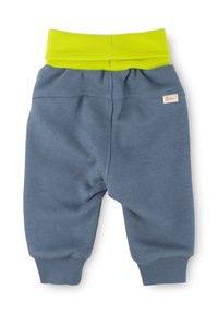 Graue Baumwoll-Jogginghosen mit einem gerippten neon-gelben Bund und Bündchen. Verfügt über ein kleines Markenlabel auf der Rückseite. Besonders weiches Material.