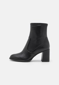 Black ankle boots made of smooth leather, featuring a rounded toe, high block heel, and a stitched top edge, with a sleek silhouette.