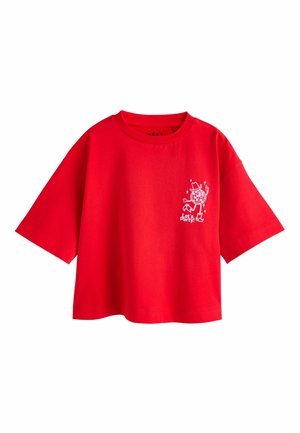 Red cotton t-shirt with short sleeves, relaxed fit, and a white printed graphic on the left side featuring a character and stars.