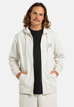 Light grey zip-up hoodie with a drawstring hood, front pockets, and a small black logo on the left chest. Made from soft fabric.