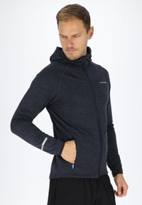 Hooded athletic jacket in dark navy, featuring a zip closure, side pockets, and reflective accents on the sleeves. Textured fabric.