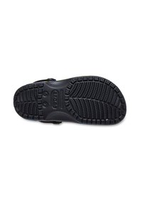 Svart Crocs-sula med texturerat greppmönster och storleksmarkeringar 5-7 på vit bakgrund.