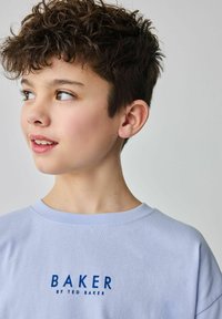 Světle modré bavlněné tričko s logem "BAKER" v tučné námořnické modři. Měkká textura, kulatý výstřih a krátké rukávy. Jednoduchý design bez vzorů.