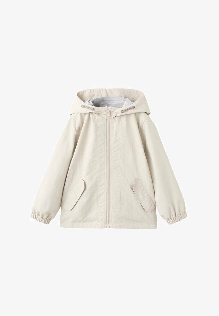 Svetlo bež jopič s kapuco iz bombažnega mešanega materiala. Ima sprednji zadrgo, elastične manšete in dva sprednja žepa. Gladek, neobložen material.