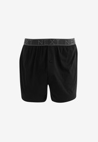 Schwarze Baumwoll-Boxershorts mit einem grauen elastischen Bund, auf dem das Wort "NEXT" wiederholt ist. Entworfen mit einem vorderen Knopfverschluss.
