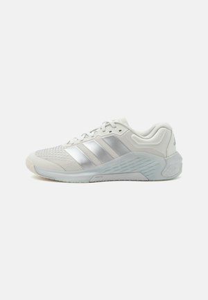 Lys grå atletiksneaker med mesh-overdel, sølv side-striber, polstret sål og snørelukning, vist på en ensfarvet hvid baggrund.