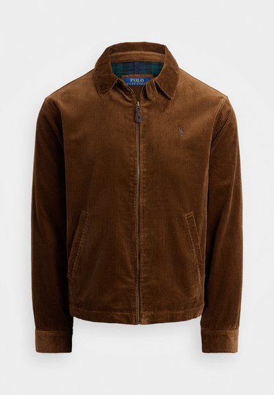 Brown corduroy jacket with a zipper front, pointed collar, and two side pockets. Features an embroidered logo on the chest.