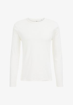 Baltas ilgomis rankovėmis marškinėliai, pagaminti iš minkštos medvilnės. Turi apykaklę su apvaliu iškirpimu ir prigludusį siluetą, be matomų raštų ar akcentų.