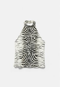 Haut sans manches col halter avec motif zèbre noir et blanc et col boutonné sur fond blanc.