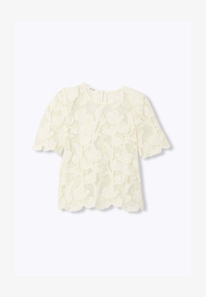 Blouse blanche en dentelle à manches courtes avec motif floral, col rond, bords festonnés et fermeture à bouton en forme de trou de serrure au dos.