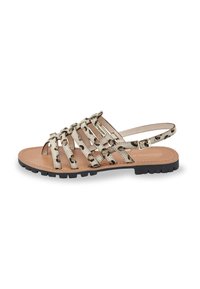 Sandali con cinturini e motivo leopardato in beige e nero, con suola piatta e una fibbia metallica sul cinturino alla caviglia.