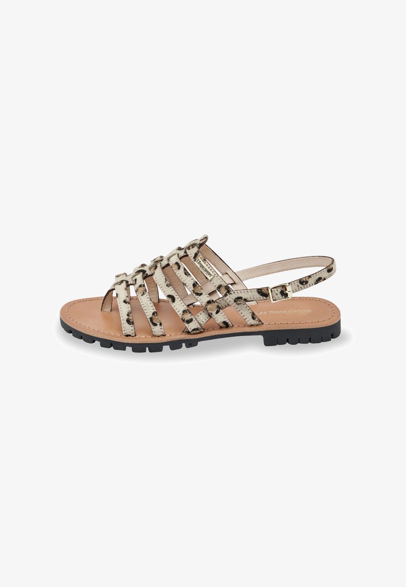 Sandal med stropper i leopardmønster i beige og sort, med flad sål og en metalspænde på ankelsnoren.