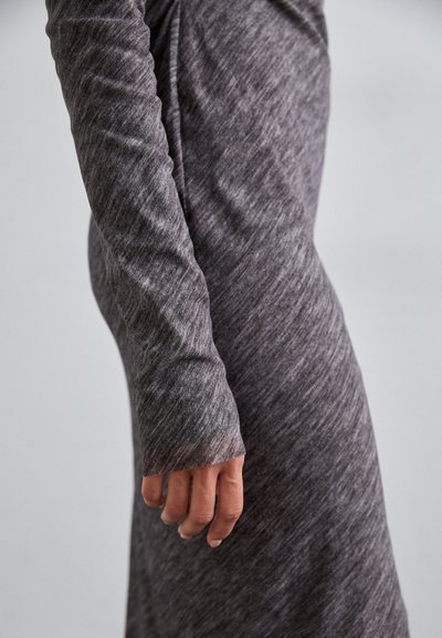 Long-sleeve, gray dress featuring a textured, heathered fabric. The sleeve ends in a thumbhole, enhancing comfort and coverage.