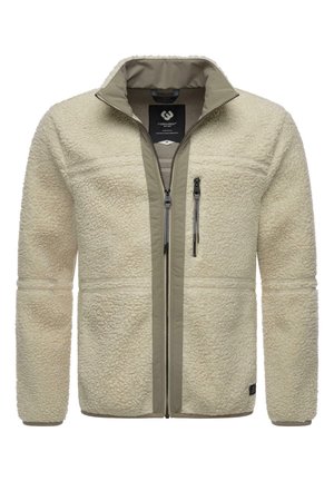 Beżowa bluza polarowa z pełnym zamkiem błyskawicznym z przodu, zapinana na zamek kieszeń na piersi, stojący kołnierz oraz miękka teksturowana tkanina.