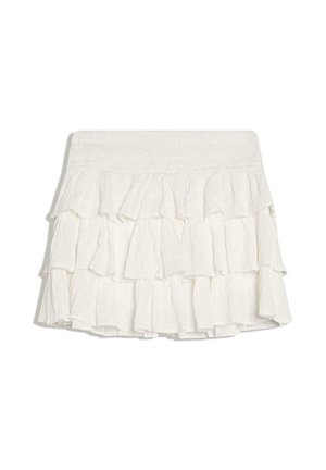 Fehér, réteges miniszoknya rugalmas derékpánttal és lágy, folyékony fodros rétegekkel.