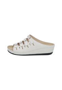 White wedge slide sandals made of textured material, featuring cut-out details and three adjustable straps. Soft, cushioned footbed and black sole.