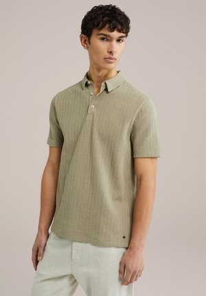 Light green short-sleeve polo shirt with a textured ribbed pattern, two-button placket, and a small logo at the hem.