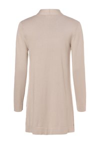 Beige långärmad topp med krage, som har en mjuk stickad textur och sidoflikar i hamn för ökad komfort och rörelsefrihet.