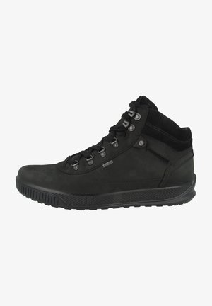 Scarpe alte nere realizzate in materiale liscio e scamosciato. Dotate di occhielli metallici, una suola in gomma testurizzata e un colletto alla caviglia imbottito.