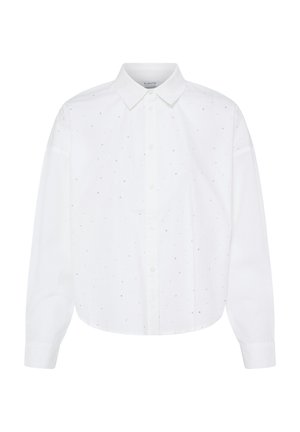 Chemise blanche à manches longues avec petits points noirs dispersés et col pointu, présentée sur fond blanc uni.
