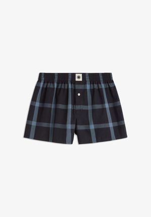 Men’s black and blue plaid boxer shorts with elastic waistband and front button closure laid flat on white background.