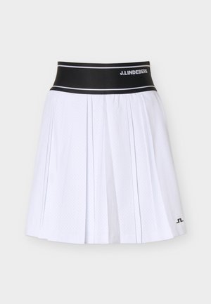 Jupe plissée blanche avec une ceinture élastique noire portant le texte « J.LINDEBERG » et un motif perforé subtil sur toute la surface.