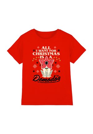 Red cotton t-shirt featuring white and black text, a floral graphic, and a cartoon creature design, with snowflake accents.