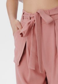 Hlače viskog struka u blush pink boji s širokim remenom na vezanje, naboranom prednjom stranom, bočnim džepovima i glatkom, čvrstom teksturom tkanine.