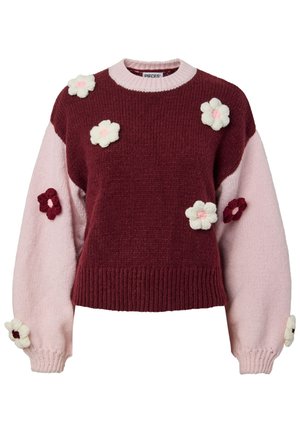Knit sweater featuring a maroon body and pale pink sleeves, adorned with knitted flower appliqués in cream and burgundy. Ribbed hem.