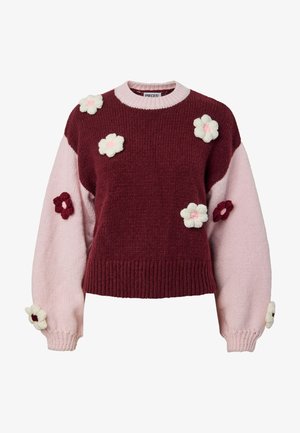 Πλεκτό πουλόβερ με μπορντό σώμα και απαλές ροζ μανσέτες, διακοσμημένο με πλεκτές εφαρμογές λουλουδιών σε κρέμα και μπορντό. Ριμπ μανσέτα.