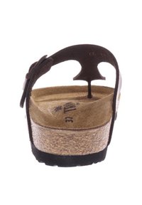 Bruine lederen sandaal met een kurken voetbed, ontwerp met een achterband en een gestructureerde zwarte zool. Maat 37 gemarkeerd op de binnenzool.