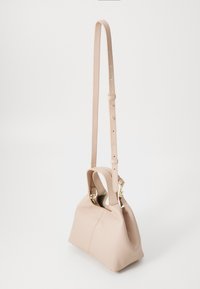 Beige leather handbag with a textured finish, short handles, and a long adjustable strap; gold-tone hardware accents.