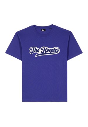Lila Baumwoll-T-Shirt mit einem weißen Logo, das in geschwungener Schrift "The Kooples" liest. Klassischer Rundhalsausschnitt und kurze Ärmel.