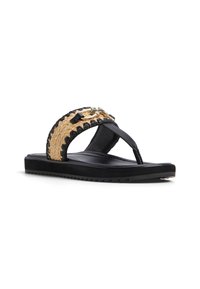Black flip-flop sandal with a woven straw-like strap, featuring gold hardware accents. The sole is flat with a textured bottom for grip.