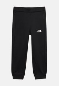 Leggings de sport noirs en matériau lisse et extensible. Présentent un logo blanc sur la cuisse gauche et des poignets ajustés aux chevilles.
