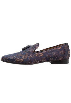 Navy blue fabric shoe featuring a paisley pattern in bronze, with a flat sole and a decorative buckle detail on the upper.