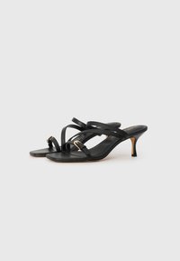 Black heeled sandals with a slim strap design, featuring a small gold buckle accent. The heels are approximately 2 inches high.