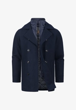 Tengerészkék gyapjú peacoat, dupla soros elülső részel, hangsúlyos gombokkal és steppelt bélésse. Klasszikus gallérral és oldalsó zsebekkel rendelkezik.