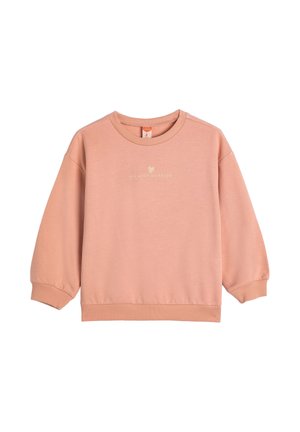 Perzikkleurige sweatshirt met lange mouwen, ribgebreide manchetten, ronde halslijn en kleine tekst met een hartje met de tekst "je maakt me blij" op de borst.