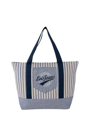 Bolsa tote de algodón a rayas con asas azul marino, que cuenta con un parche con logo y cierre de cremallera. El diseño incluye rayas verticales azules y crema.